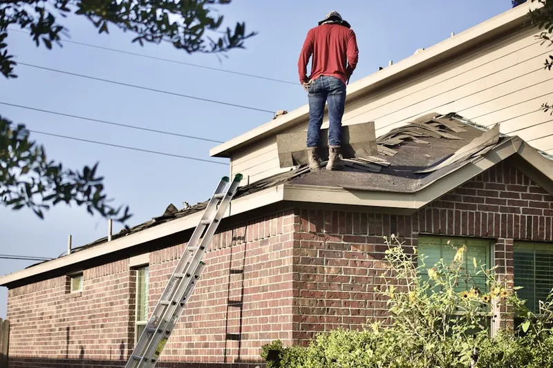 Professional roofer working on a residential roof in Dunwoody Panhandle